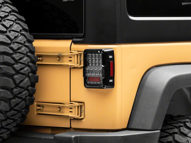 Raxiom J141596 - RAXJ141596 - Raxiom 07-18 Jeep Wrangler JK Axial Series Lux LED Tail Lights- Black Housing (Clear Lens) - Shipped in Europe - Tuningsupply.com