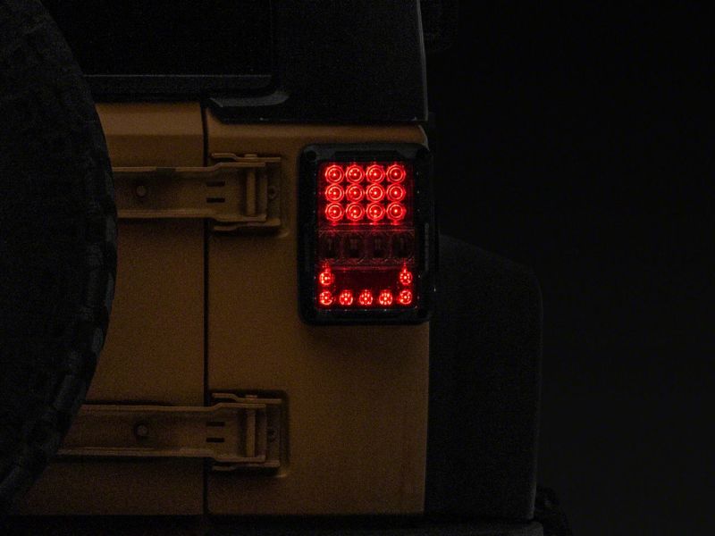 Raxiom J141596 - RAXJ141596 - Raxiom 07-18 Jeep Wrangler JK Axial Series Lux LED Tail Lights- Black Housing (Clear Lens) - Shipped in Europe - Tuningsupply.com