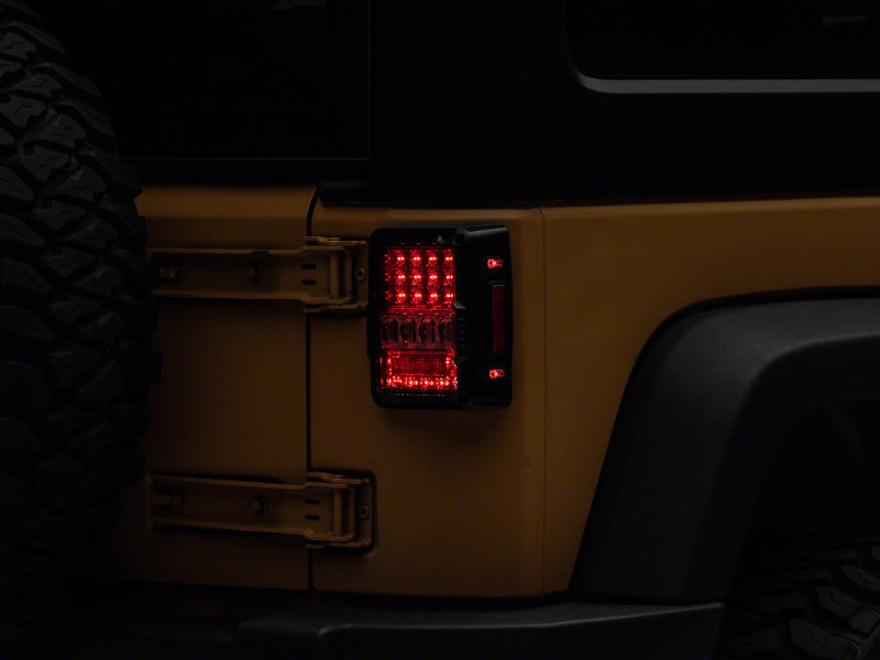 Raxiom J141596 - RAXJ141596 - Raxiom 07-18 Jeep Wrangler JK Axial Series Lux LED Tail Lights- Black Housing (Clear Lens) - Shipped in Europe - Tuningsupply.com