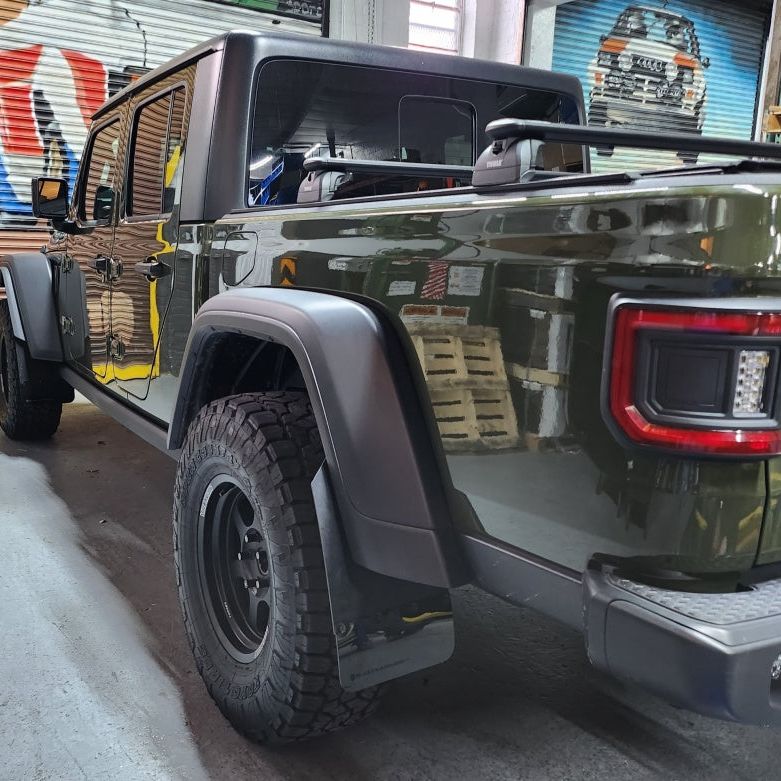 Rally Armor MF104-BLK-MBK - RALMF104-BLK-MBK - Rally Armor 19-25 Jeep JT Gladiator (Mojave/Rubicon) Black Mud Flap w/Metallic Black Logo - Shipped in Europe - Tuningsupply.com