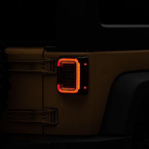 Raxiom J138358 - RAXJ138358 - Raxiom 07-18 Jeep Wrangler JK Axial Series LED Halo Tail Lights- Black Housing (Dark Smoked Lens) - Shipped in Europe - Tuningsupply.com