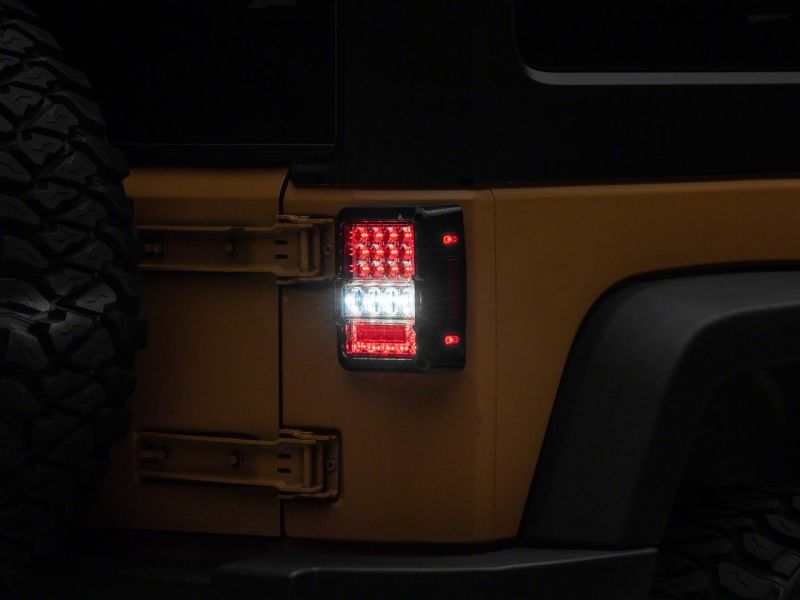 

Raxiom J141596 - RAXJ141596 - Raxiom 07-18 Jeep Wrangler JK Axial Series Lux LED Tail Lights- Black Housing (Clear Lens) - Shipped in Europe - Tuningsupply.com
