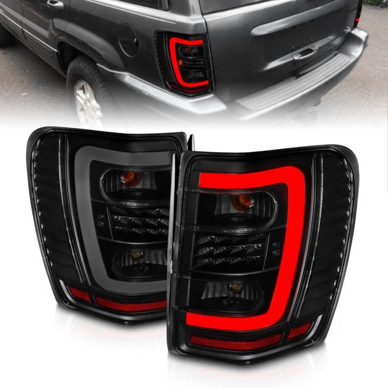 ANZO 1999-2004 Jeep Grand Cherokee LED Tail Lights w/ Light Bar Black Housing Smoke Lens-tuningsupply.com